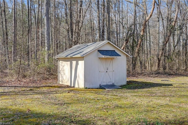 view of shed with a forest view