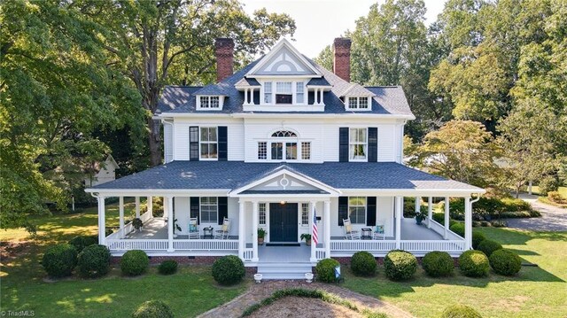 view of front of house with a front yard and a porch