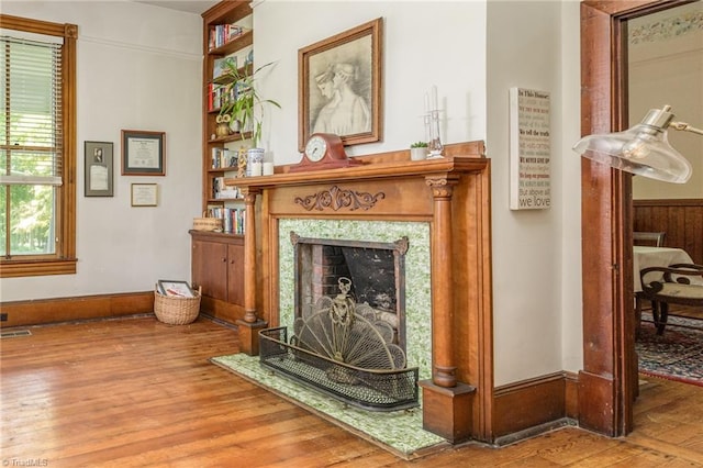 sitting room with a premium fireplace and hardwood / wood-style flooring