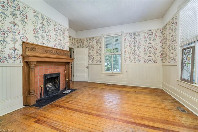 unfurnished living room with hardwood / wood-style floors and a fireplace