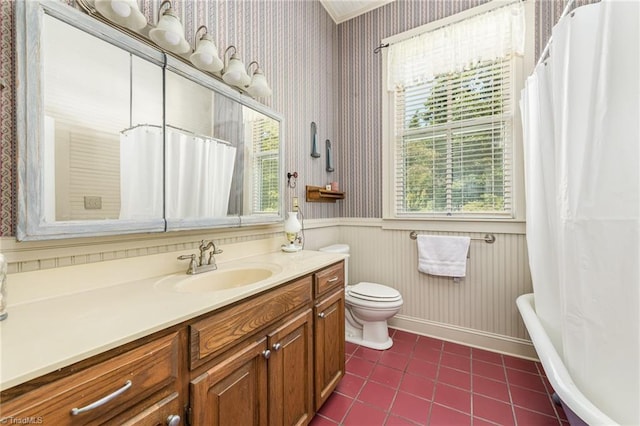 bathroom featuring tile patterned floors, a bathtub, toilet, and vanity