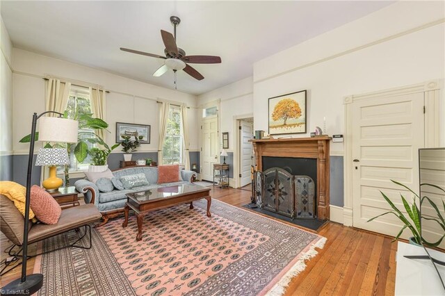 living room with a healthy amount of sunlight, ceiling fan, and hardwood / wood-style floors