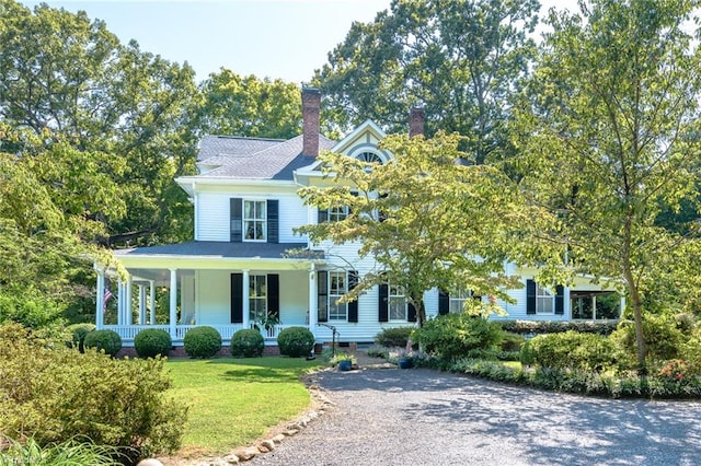 view of front of house with a front yard and a porch