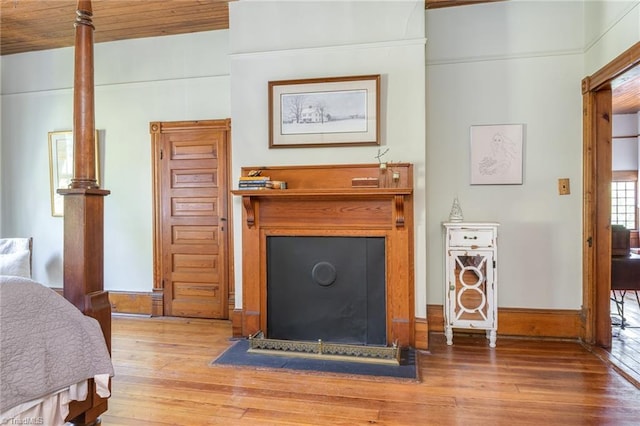 bedroom with wooden ceiling and hardwood / wood-style floors