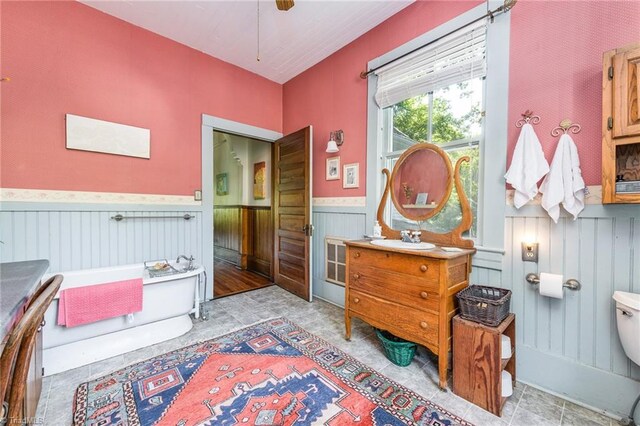 bedroom featuring sink and wooden walls