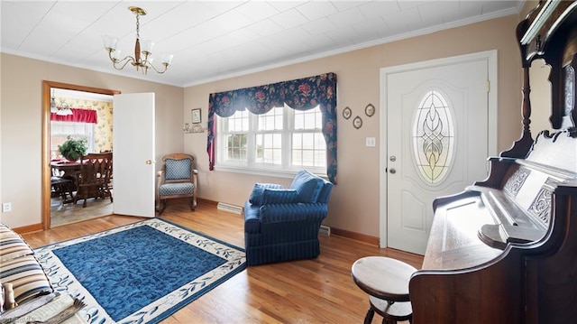 interior space with hardwood / wood-style floors, a notable chandelier, and ornamental molding