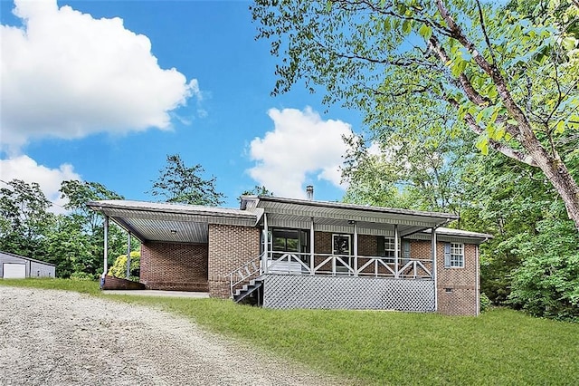 5948 Muddy Creek Rd, Archdale, NC 27263 - manufactured / mobile home with brick siding, covered porch, a front lawn, and dirt driveway