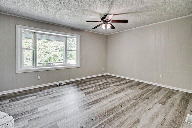 5948 Muddy Creek Rd, Archdale, NC 27263 - spare room featuring a ceiling fan, wood finished floors, a textured ceiling, crown molding, and baseboards