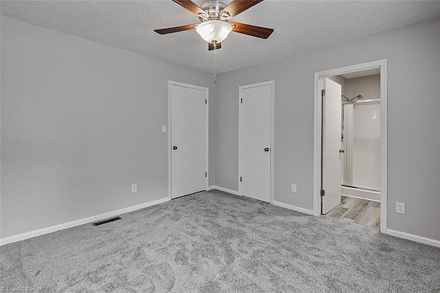5948 Muddy Creek Rd, Archdale, NC 27263 - unfurnished bedroom featuring carpet, a textured ceiling, baseboards, ensuite bathroom, and ceiling fan