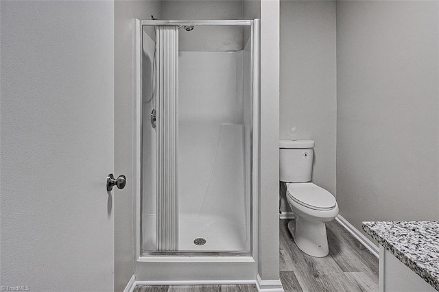 5948 Muddy Creek Rd, Archdale, NC 27263 - bathroom with wood finished floors, a shower stall, baseboards, and toilet