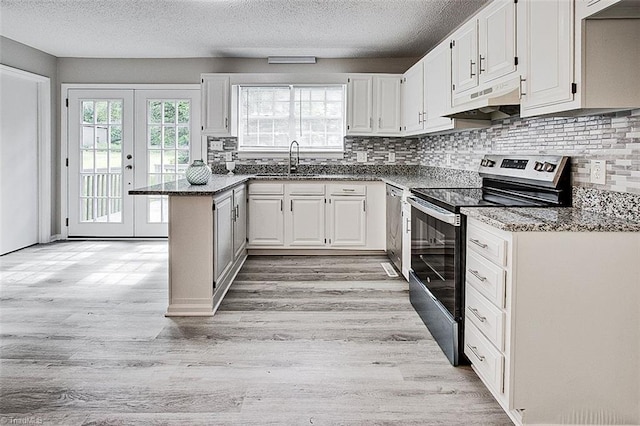 5948 Muddy Creek Rd, Archdale, NC 27263 - kitchen featuring stainless steel appliances, under cabinet range hood, light wood-type flooring, a peninsula, and a textured ceiling