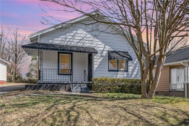 view of front of house featuring a porch and a yard