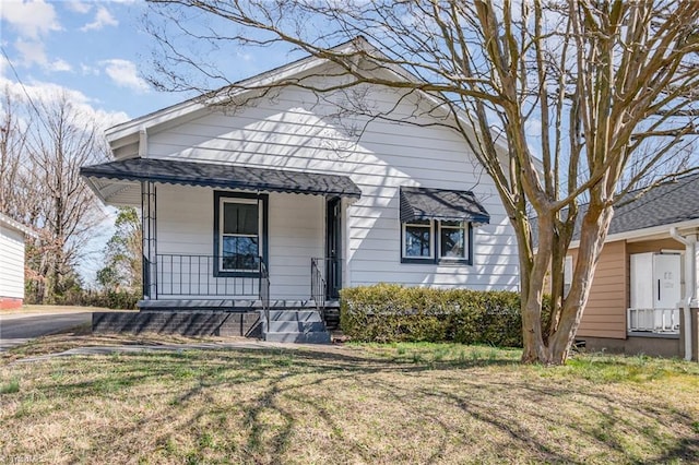 view of front of home with a front lawn and a porch