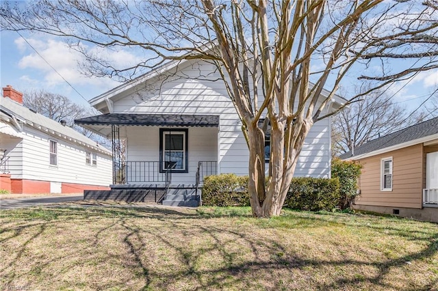 view of front of property with a porch and a front yard