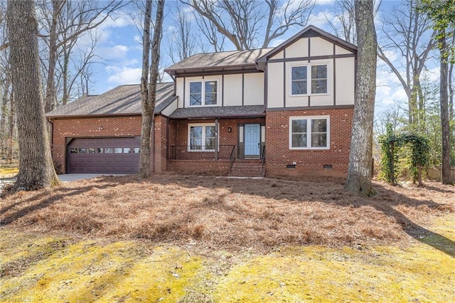 tudor-style house featuring a garage, brick siding, roof with shingles, crawl space, and stucco siding