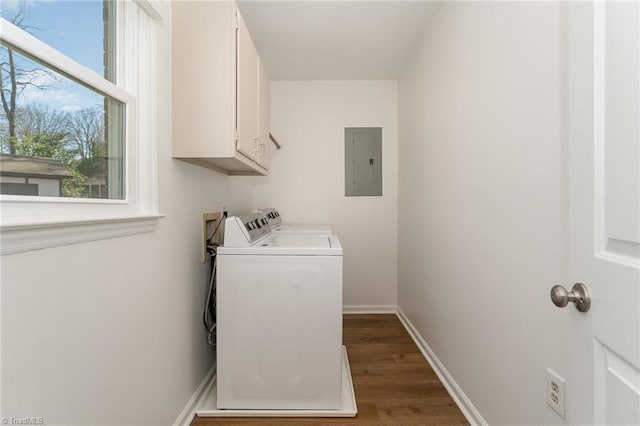 laundry room with washing machine and clothes dryer, cabinet space, dark wood-type flooring, electric panel, and baseboards