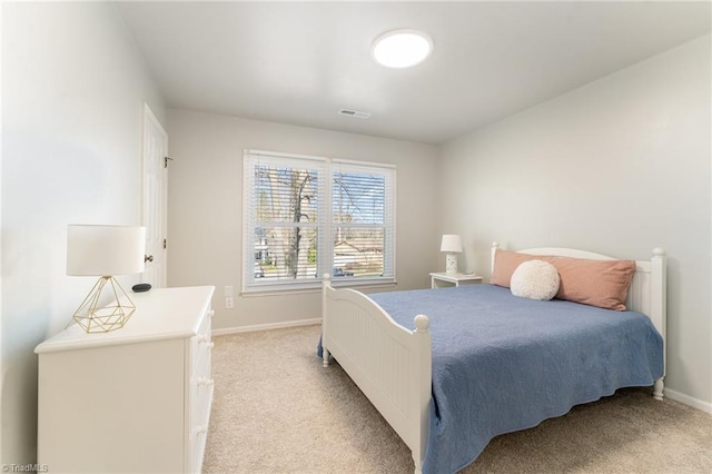 bedroom featuring visible vents, baseboards, and light colored carpet