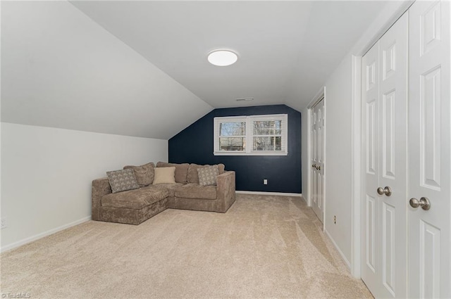 living area featuring light carpet, visible vents, baseboards, and lofted ceiling