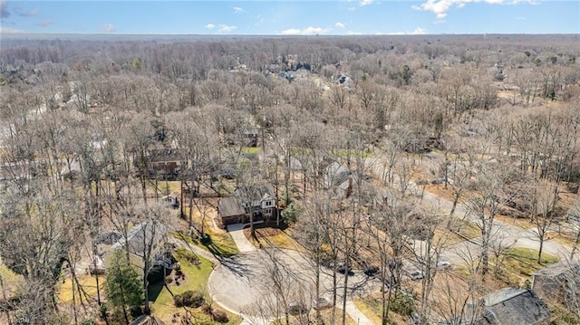 birds eye view of property with a view of trees