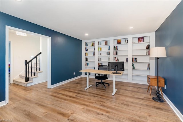 office space with recessed lighting, baseboards, and light wood finished floors