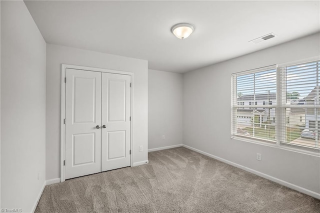 635 Cam Cir, High Point, NC 27265 - unfurnished bedroom with light carpet, baseboards, and a closet