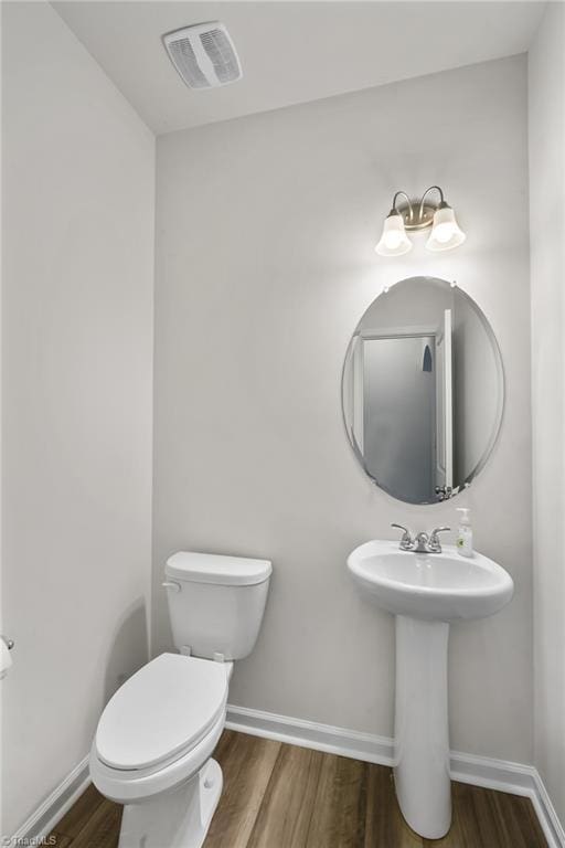 635 Cam Cir, High Point, NC 27265 - bathroom with wood finished floors, toilet, and baseboards