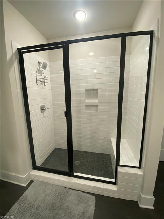 bathroom featuring walk in shower and tile patterned floors