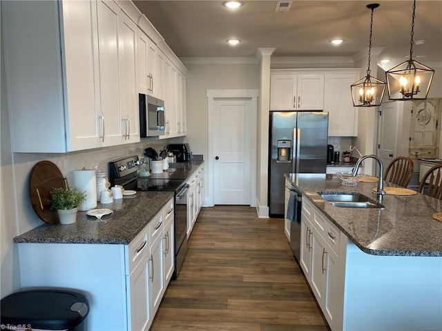 kitchen with white cabinets, stainless steel appliances, pendant lighting, and sink