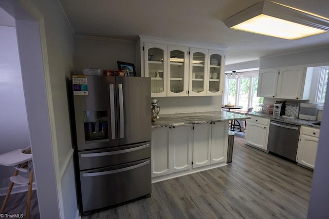 123 Greenbriar St, Mount Airy, NC 27030 - kitchen featuring stainless steel appliances, ornamental molding, white cabinetry, glass insert cabinets, and light stone counters