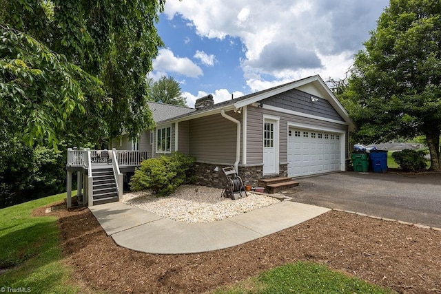 123 Greenbriar St, Mount Airy, NC 27030 - single story home with stone siding, stairs, an attached garage, asphalt driveway, and a chimney