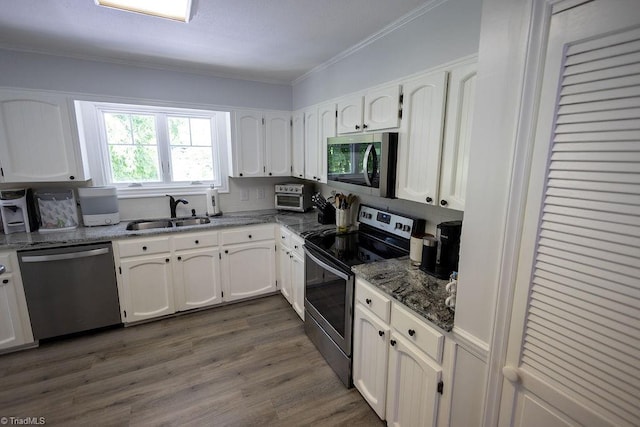 123 Greenbriar St, Mount Airy, NC 27030 - kitchen with stainless steel appliances, white cabinets, crown molding, stone counters, and dark wood-type flooring