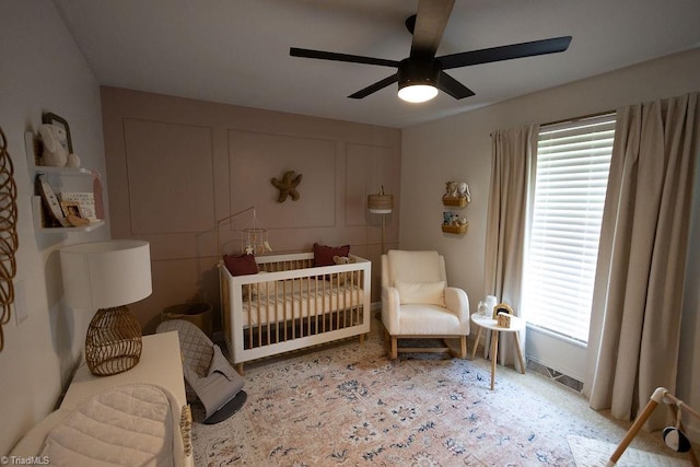 123 Greenbriar St, Mount Airy, NC 27030 - bedroom featuring a crib, multiple windows, and a ceiling fan
