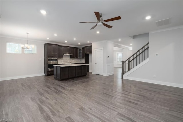 kitchen featuring dark wood-type flooring, hanging light fixtures, and ornamental molding