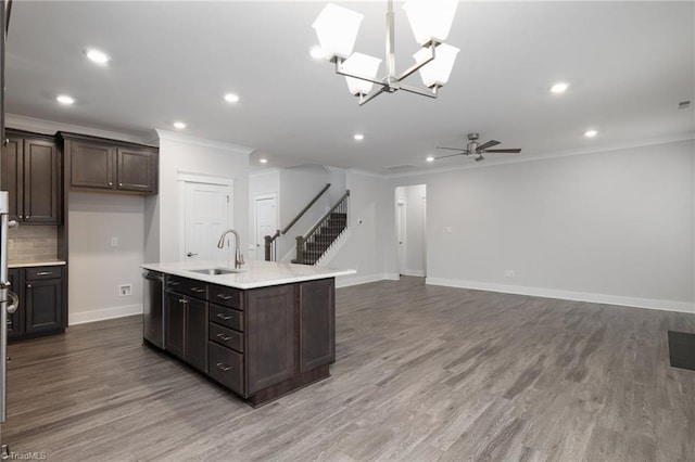 kitchen with hardwood / wood-style floors, sink, stainless steel dishwasher, and ceiling fan with notable chandelier