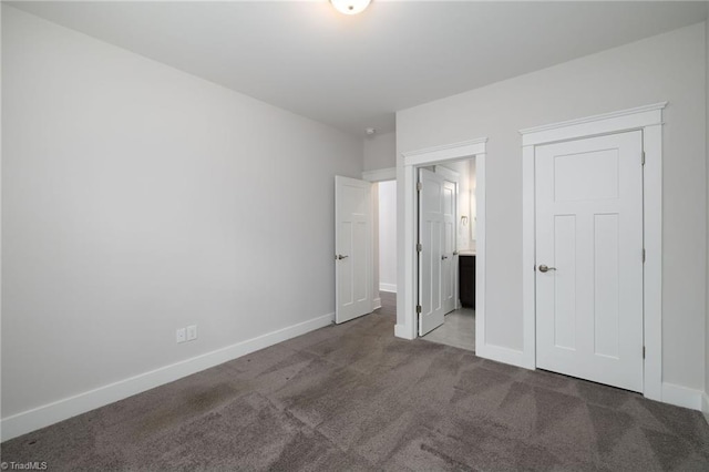 unfurnished bedroom featuring dark colored carpet