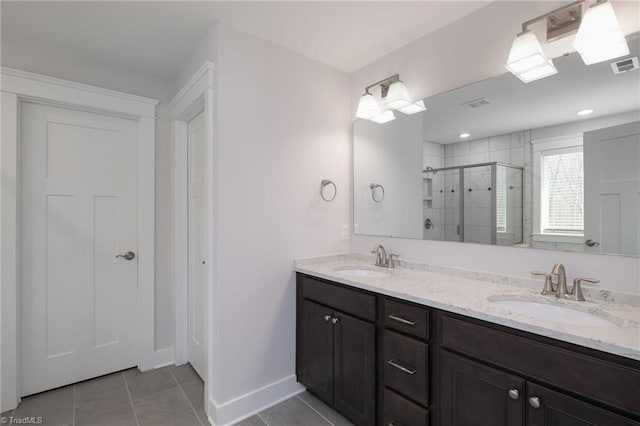 bathroom with tile patterned floors, vanity, and a shower with shower door