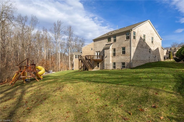 back of house with a yard, a playground, and a wooden deck