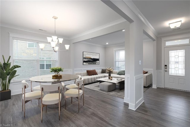 dining room featuring a healthy amount of sunlight, crown molding, and dark wood-type flooring