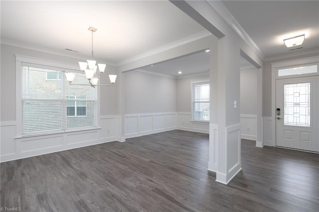 entryway featuring a chandelier, dark hardwood / wood-style floors, and ornamental molding