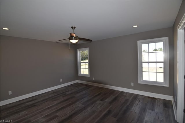 empty room with ceiling fan, dark wood-type flooring, and a healthy amount of sunlight