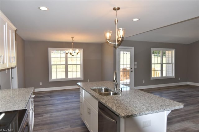 kitchen featuring appliances with stainless steel finishes, dark wood-type flooring, a center island with sink, and white cabinets