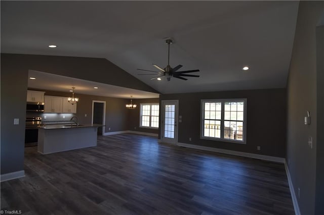 unfurnished living room with lofted ceiling, ceiling fan, dark hardwood / wood-style flooring, and sink