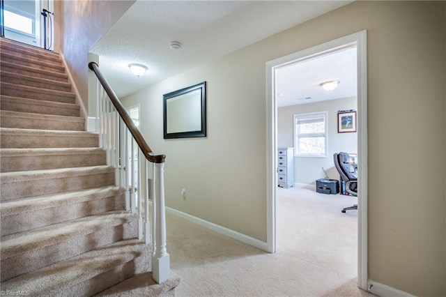 staircase with carpet and baseboards