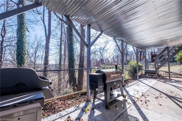 view of patio / terrace with stairway, fence, and a grill