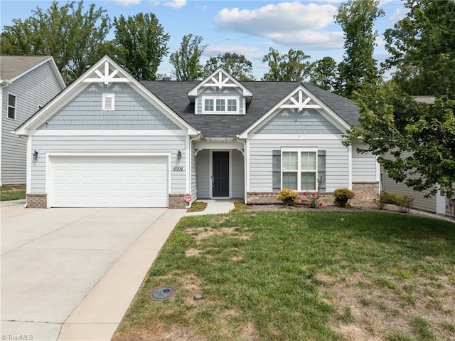 craftsman inspired home with brick siding, driveway, an attached garage, and a front yard