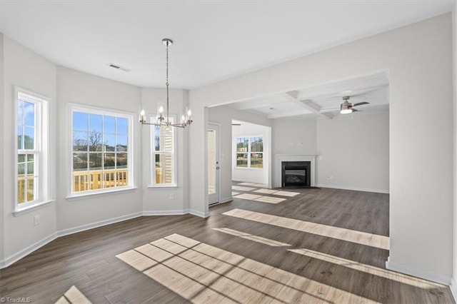 unfurnished living room with coffered ceiling, beam ceiling, dark wood-type flooring, and ceiling fan with notable chandelier