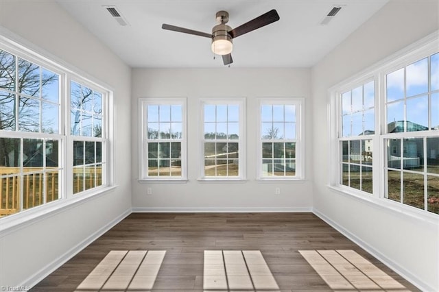 unfurnished sunroom featuring ceiling fan