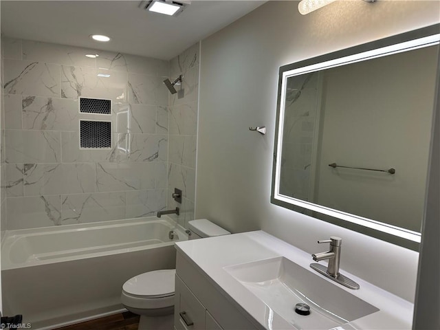 bathroom featuring recessed lighting, tub / shower combination, toilet, and vanity