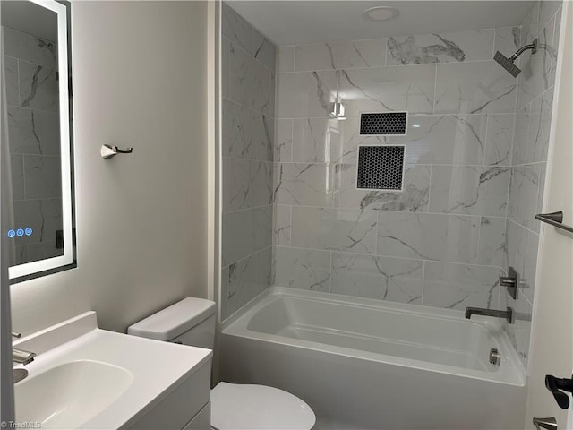 bathroom featuring vanity, shower / bathing tub combination, and toilet