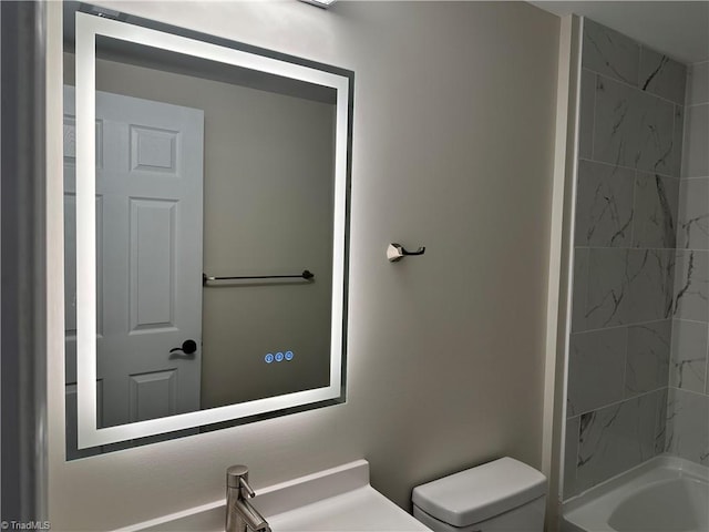 full bathroom featuring vanity, toilet, and tiled shower / bath combo